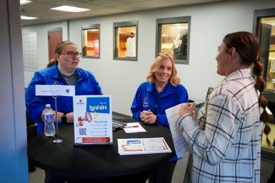 A student talks to two employers at Doane University’s Employer Connections Event 